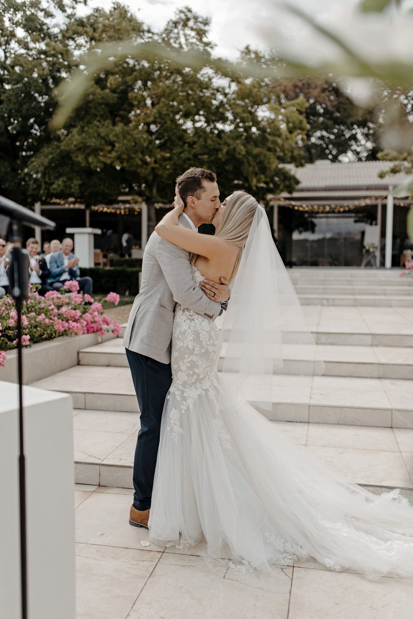 Couple embracing during an outdoor wedding ceremony.