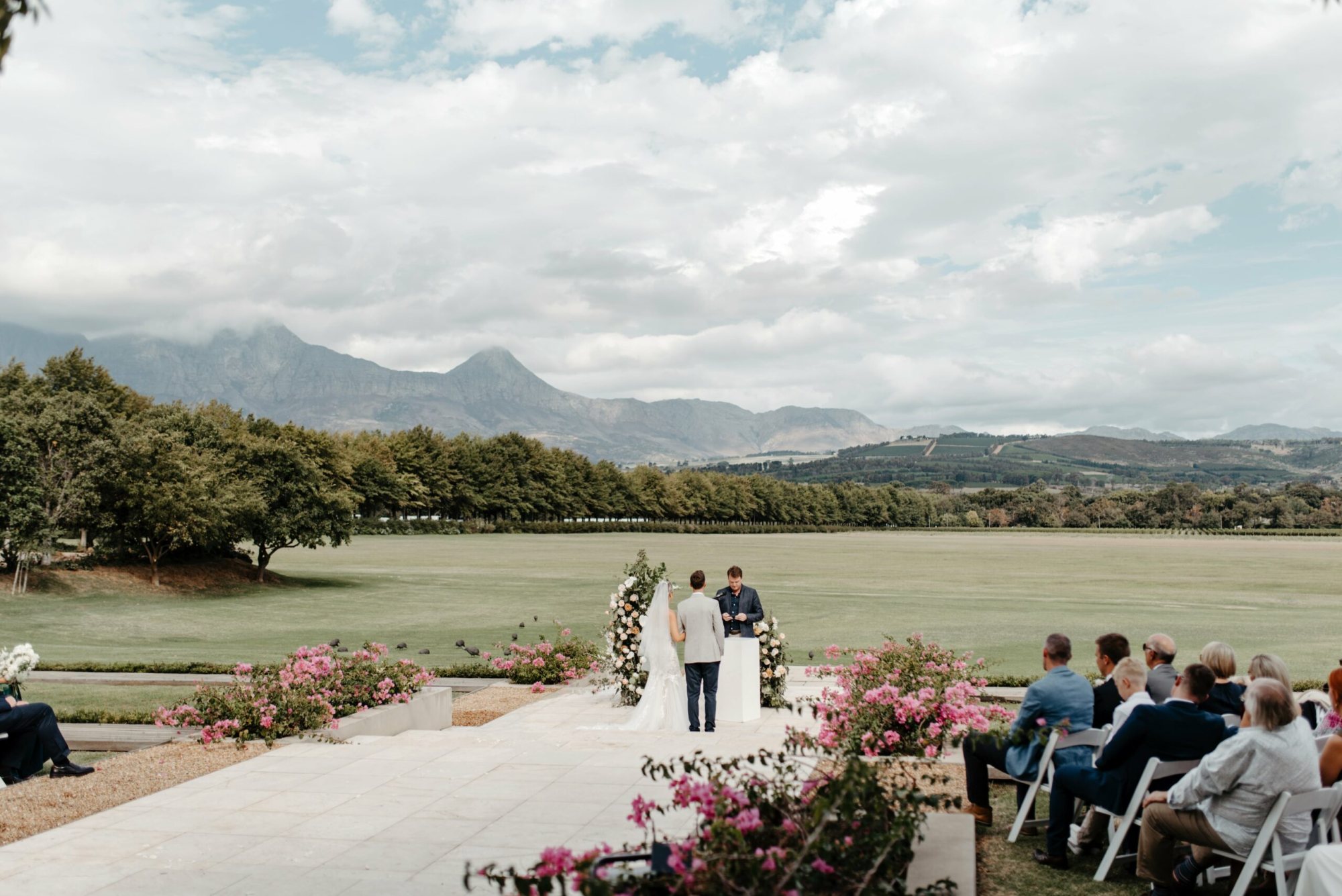 Outdoor wedding ceremony at Laurent at Lourensford with mountains and flowers
