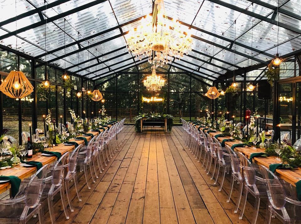 Interior view of a decorated event space with tables and chandeliers