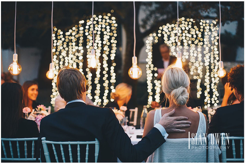 Romantic fairy lights illuminating an event space with guests seated.