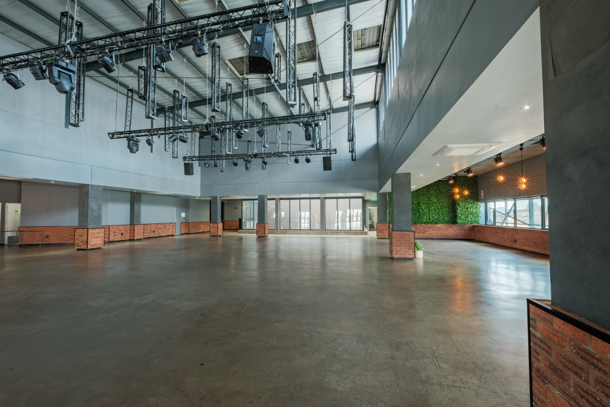Empty spacious event hall with high ceilings and lighting