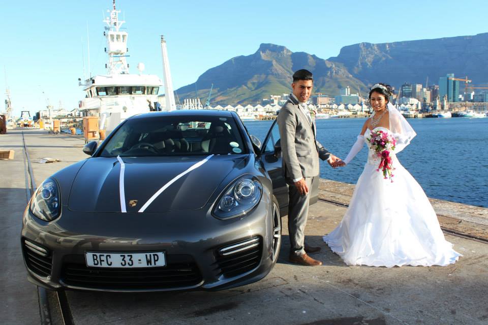 Couple with luxury Porsche and Table Mountain in the background