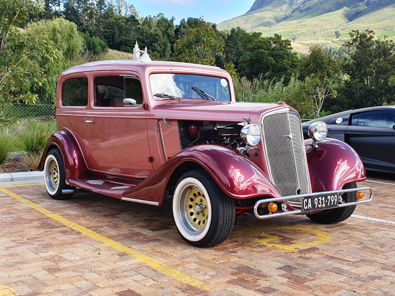 Vintage 1934 car parked with scenic backdrop