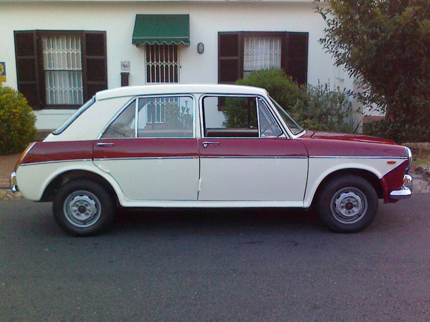 Side view of a vintage car in a classic color scheme