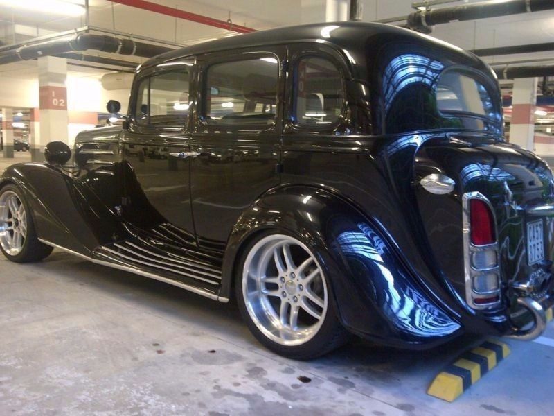 Classic vintage car with polished black exterior and silver rims.