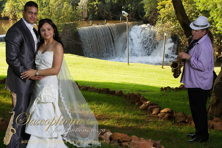 Couple with saxophonist at a waterfall backdrop