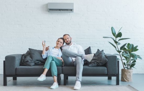 Couple relaxing on a modern couch in a bright room
