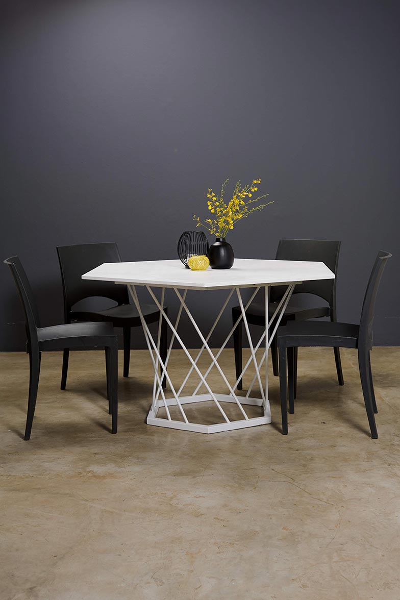 A modern dining set with a white table and black chairs