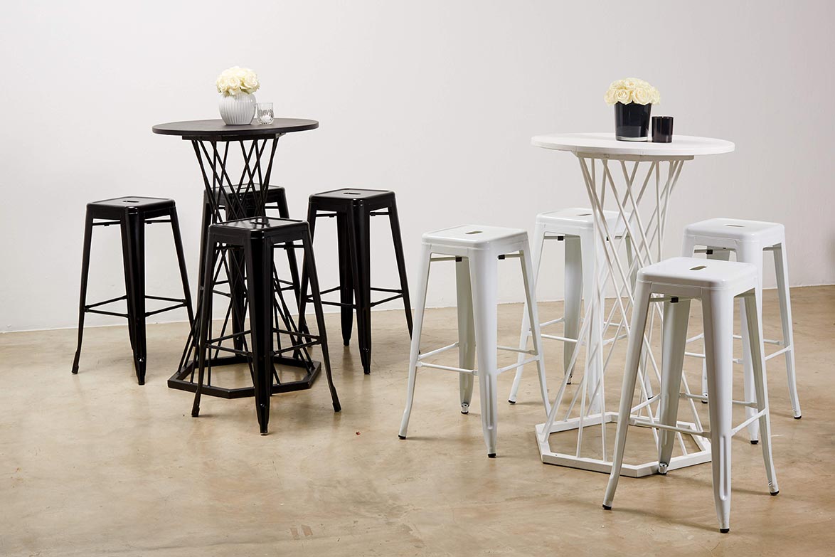 Black and white cocktail tables with stools in a stylish setup.