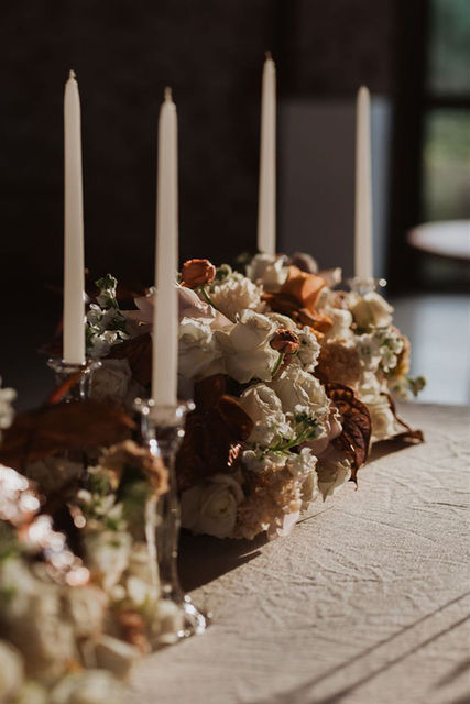 Floral centerpieces with white flowers and candles
