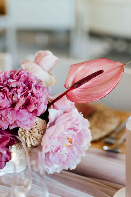 Close-up of a floral arrangement with peonies and anthuriums