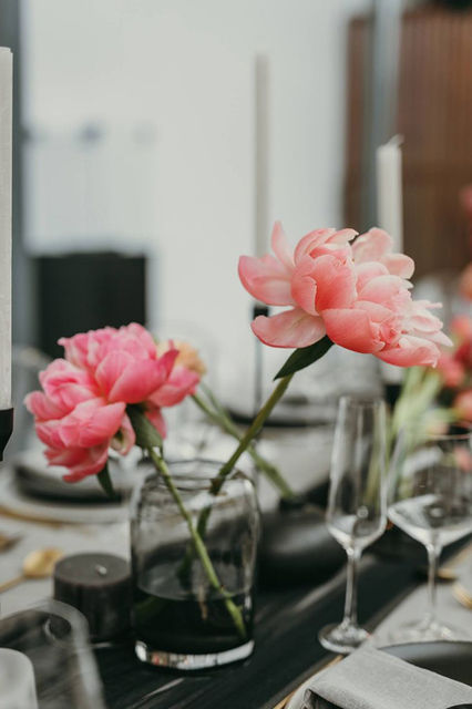Floral centerpieces with pink peonies in glass jars
