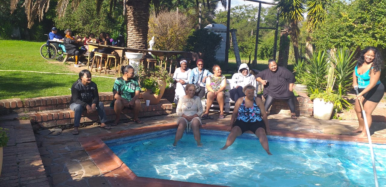 Group of people enjoying time by the pool at Love Nature venue.