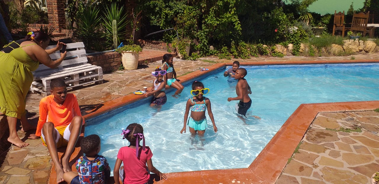 Children playing in a swimming pool at Love Nature venue