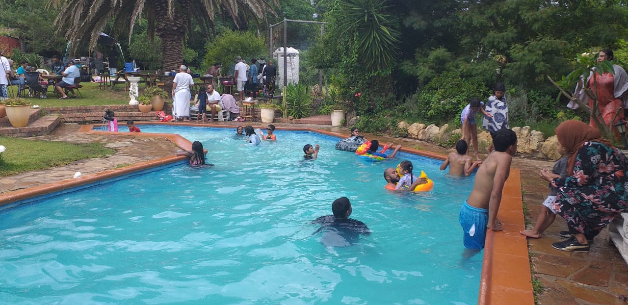 Guests enjoying a swimming pool at Love Nature venue.