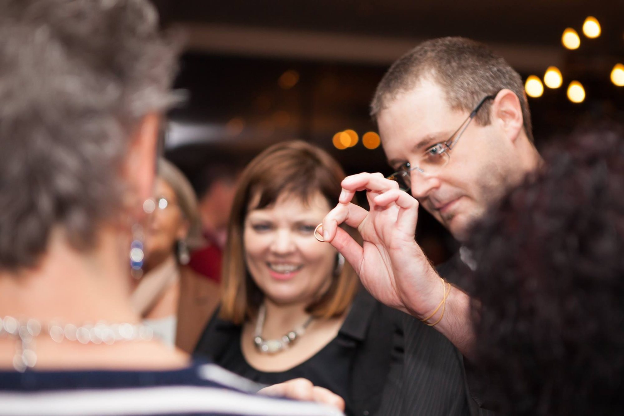 Magician performing a trick for an engaged audience.