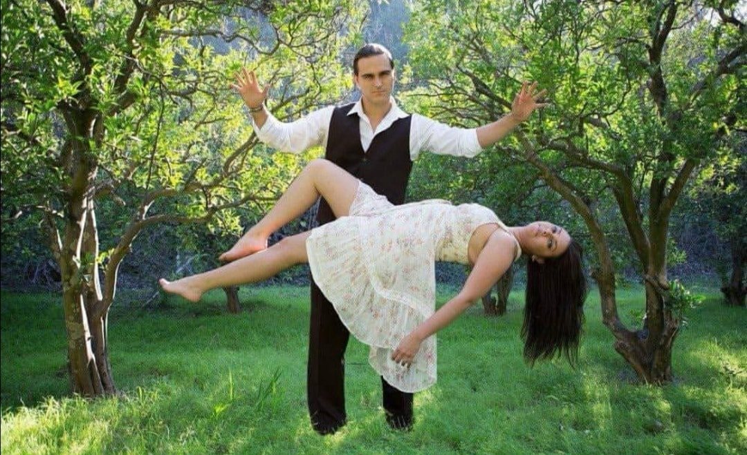 Illusionist performing with a woman in a natural setting