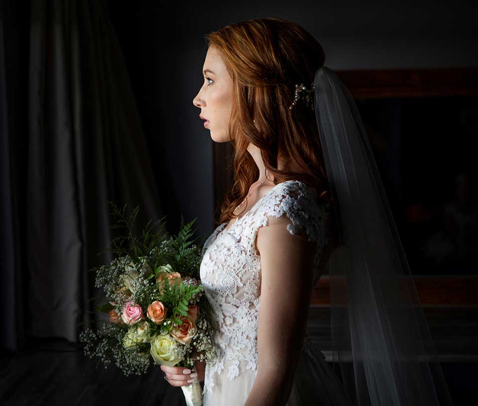 Bride in profile with veil and bouquet