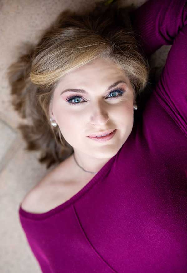 Close-up of a woman with bridal makeup and styled hair.