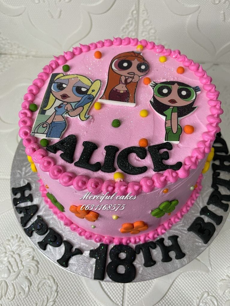 Pink birthday cake with character toppers and decorative text