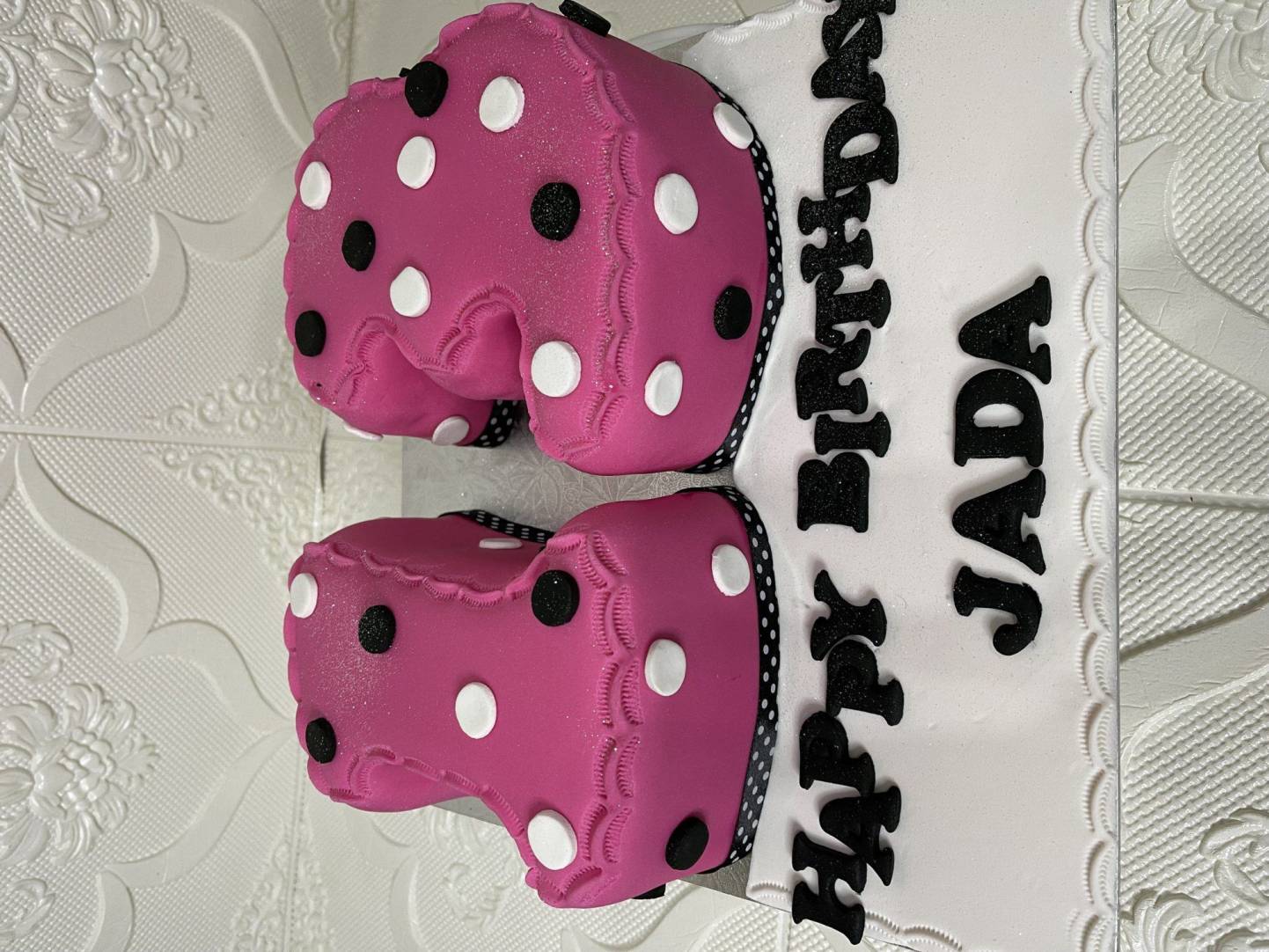 Two-tier pink birthday cake with polka dots for Jada