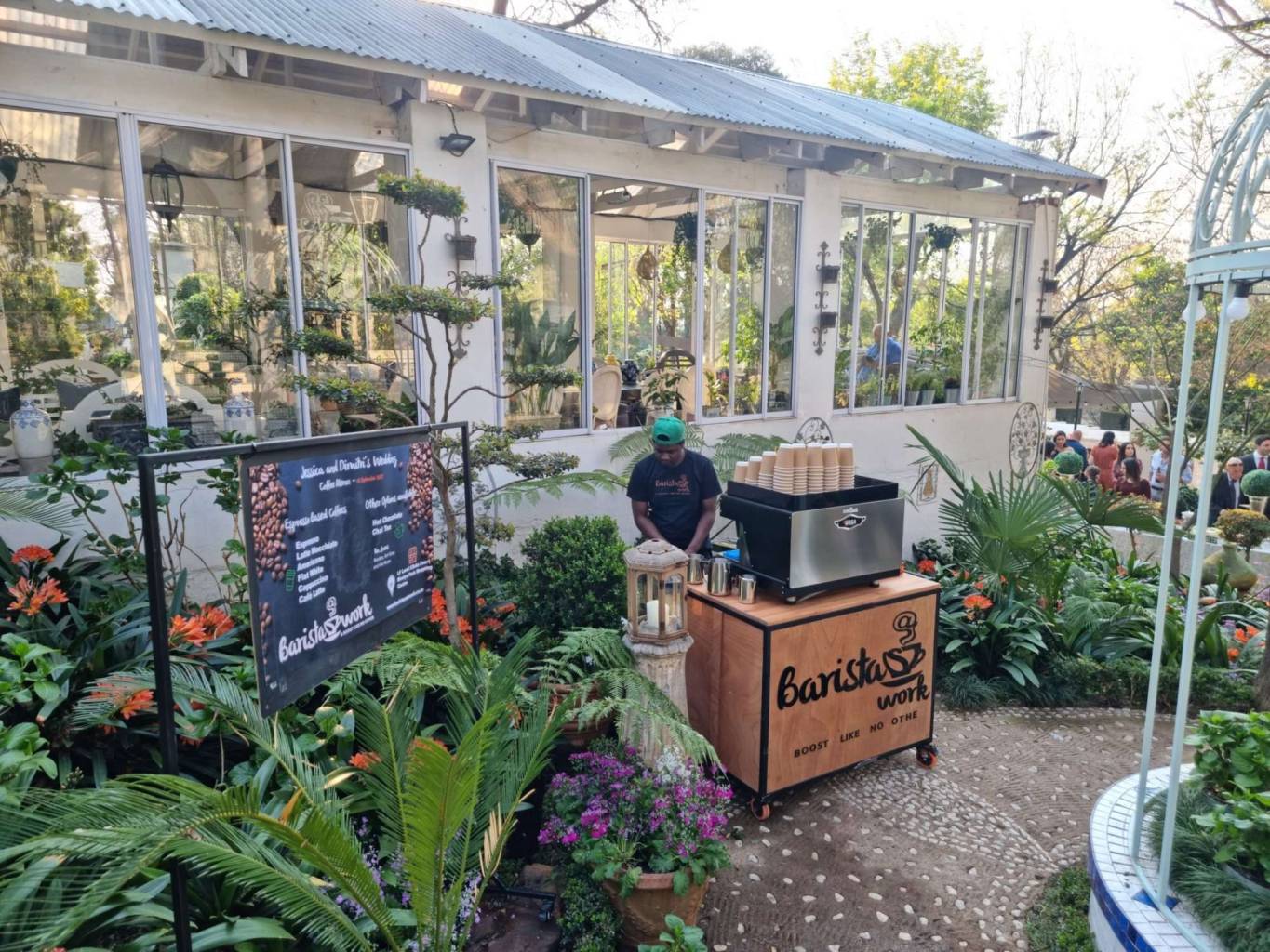 Barista at a mobile coffee setup in a garden