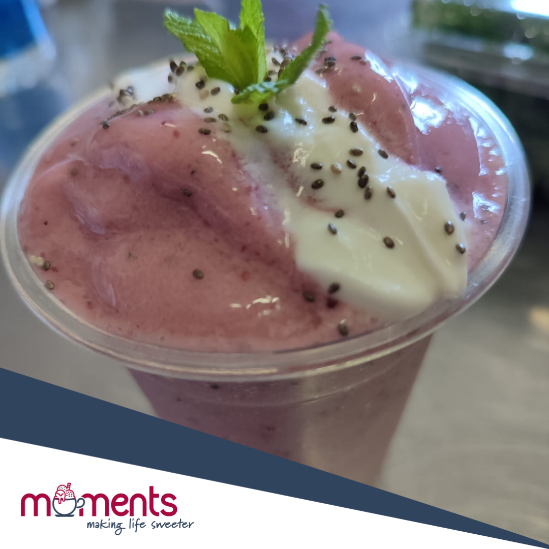 Soft serve dessert in a cup with mint and chia seeds