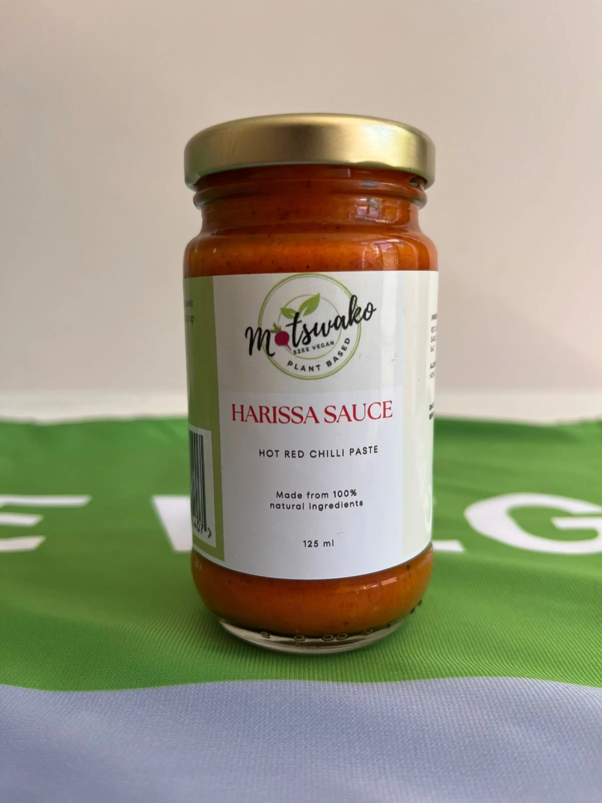Jar of Harissa Sauce on a green surface