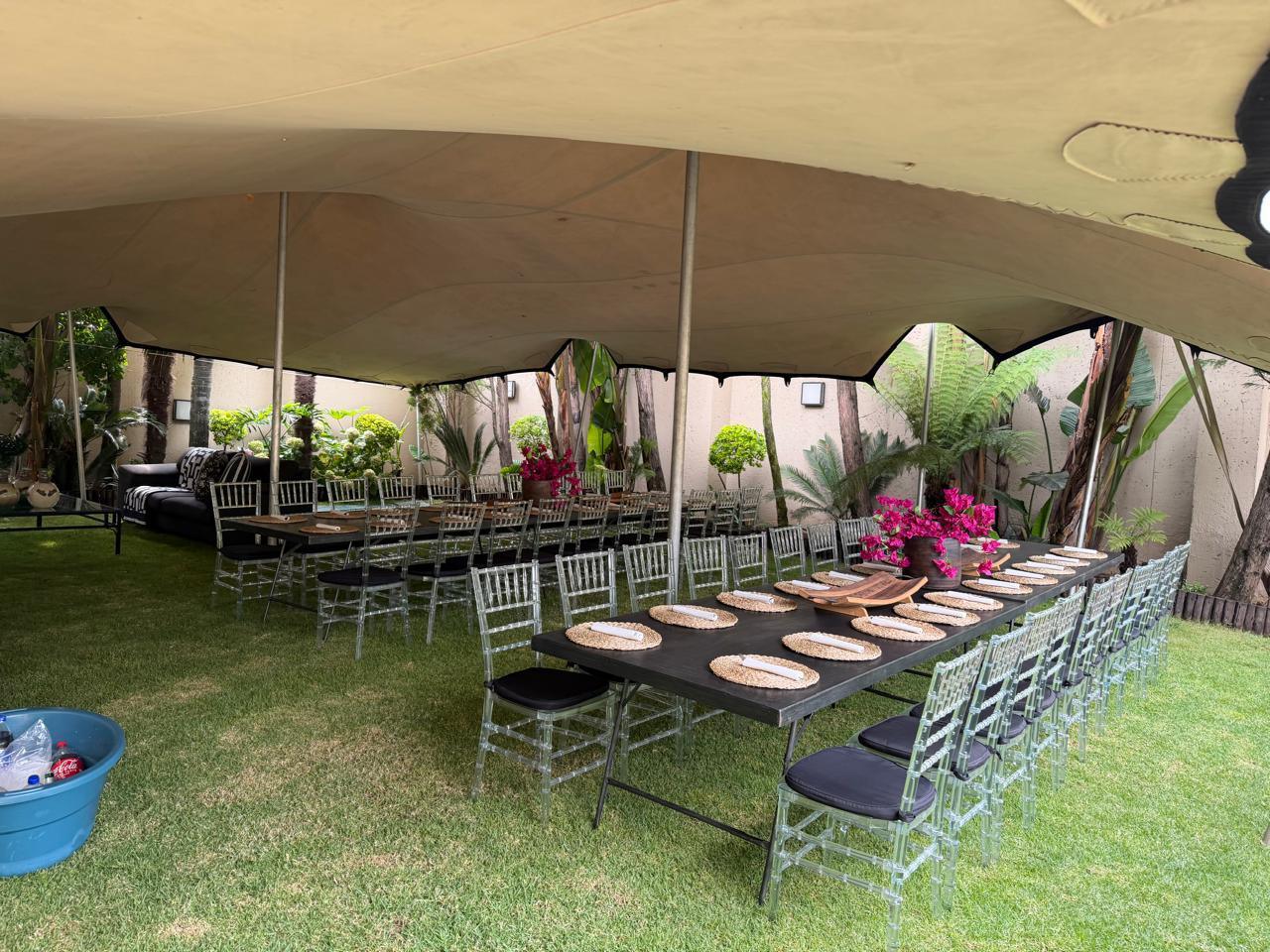 Marquee event setup with tables and chairs