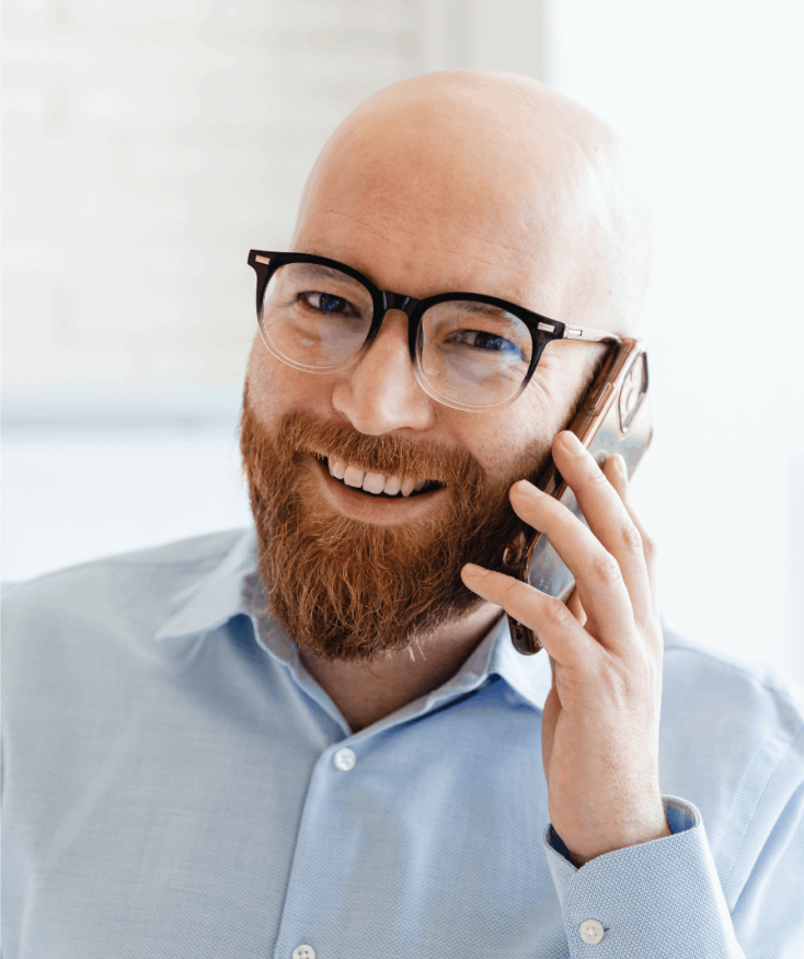 Man in glasses speaking on the phone
