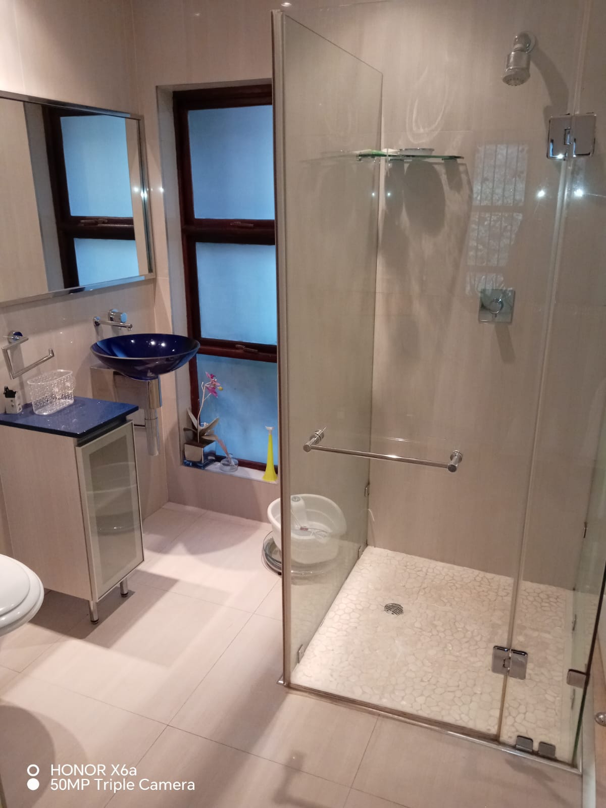 Modern bathroom with glass shower and sleek fixtures