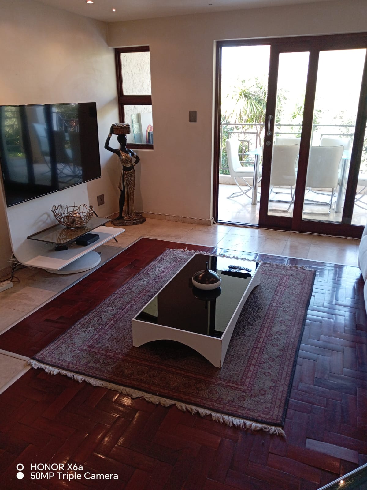 Stylish lounge with TV, coffee table, and African art