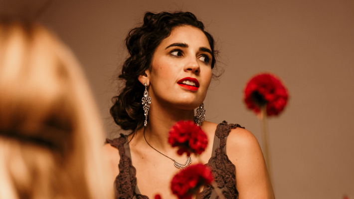 Woman in a floral setup engaged in conversation