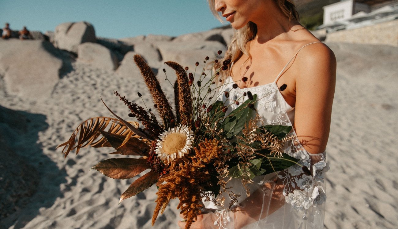 Bridal bouquet featuring seasonal flowers and greenery.