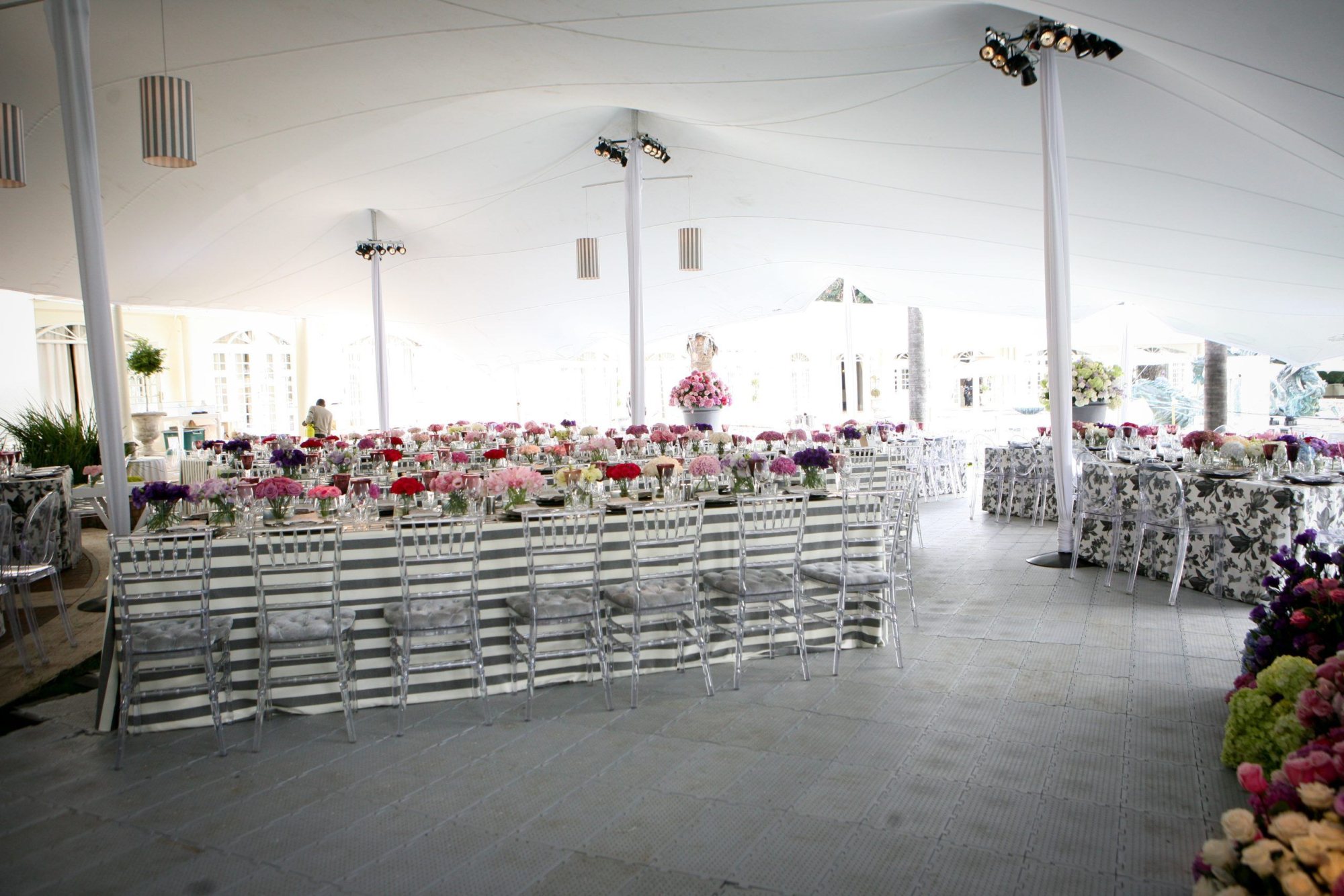 Interior of a stretch tent with tables and floral decorations