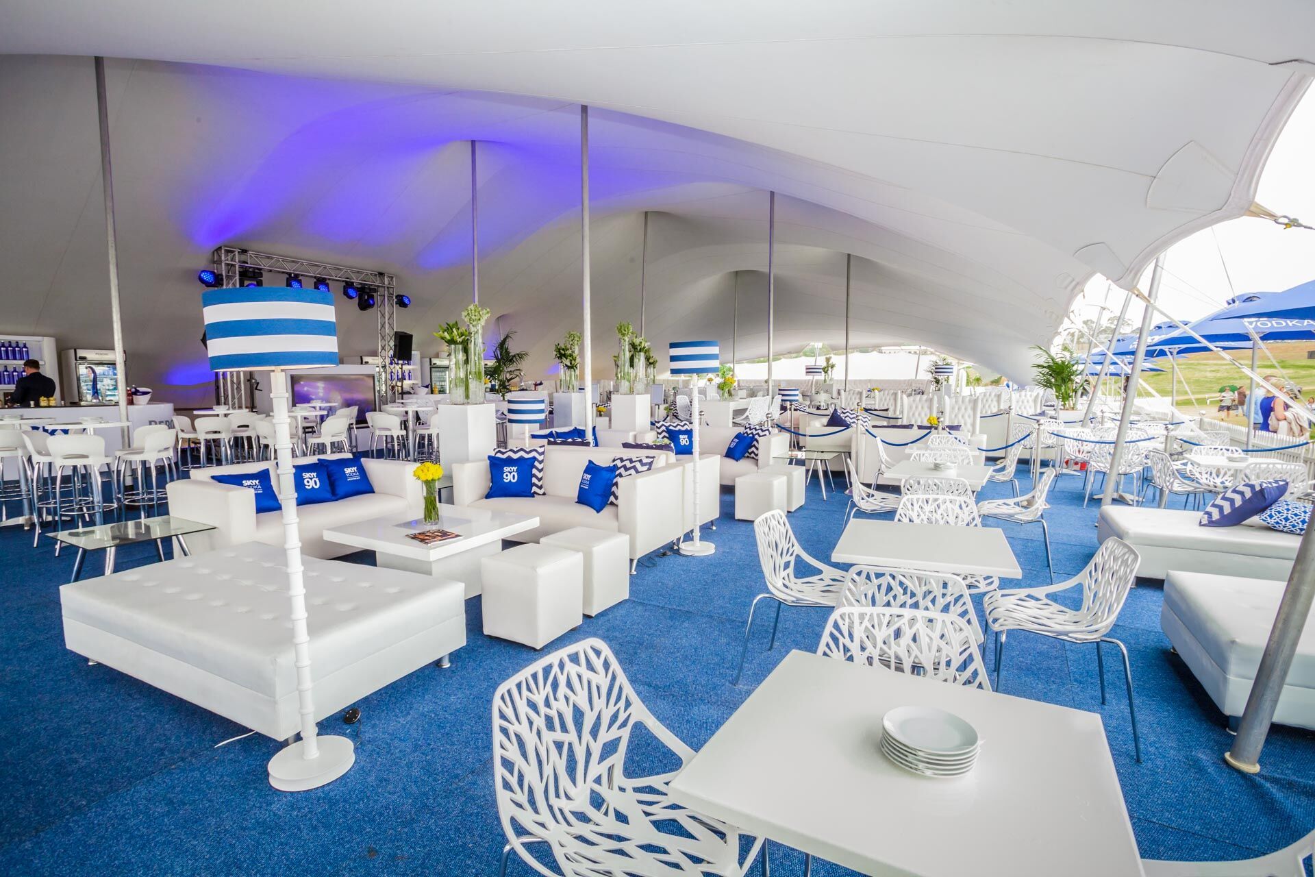 Interior view of a stylishly arranged stretch tent with seating and decor