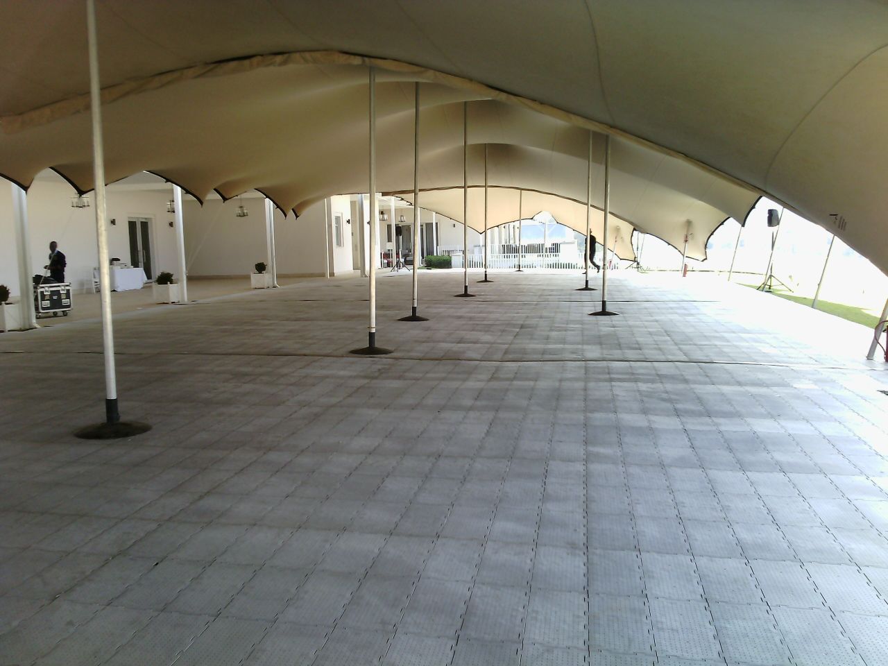 Empty space under a stretch tent with flooring.