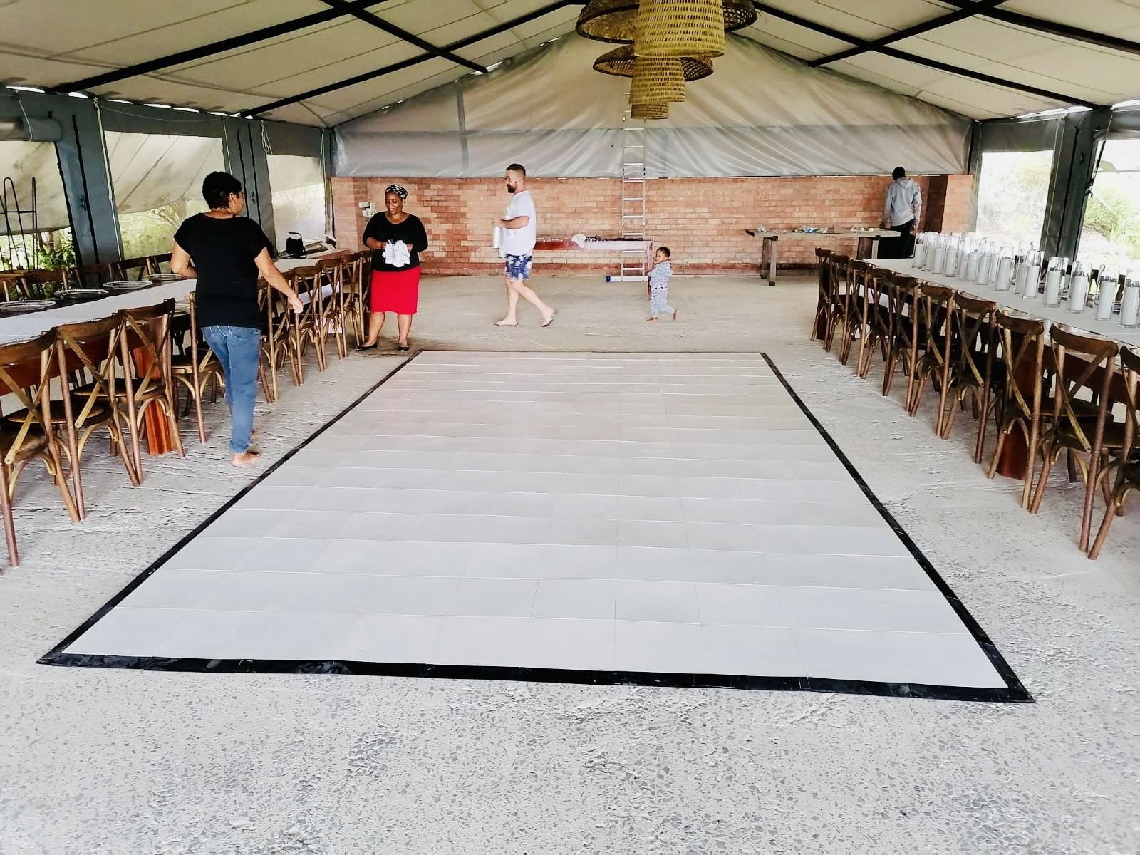 Indoor event dance floor setup in a tented venue