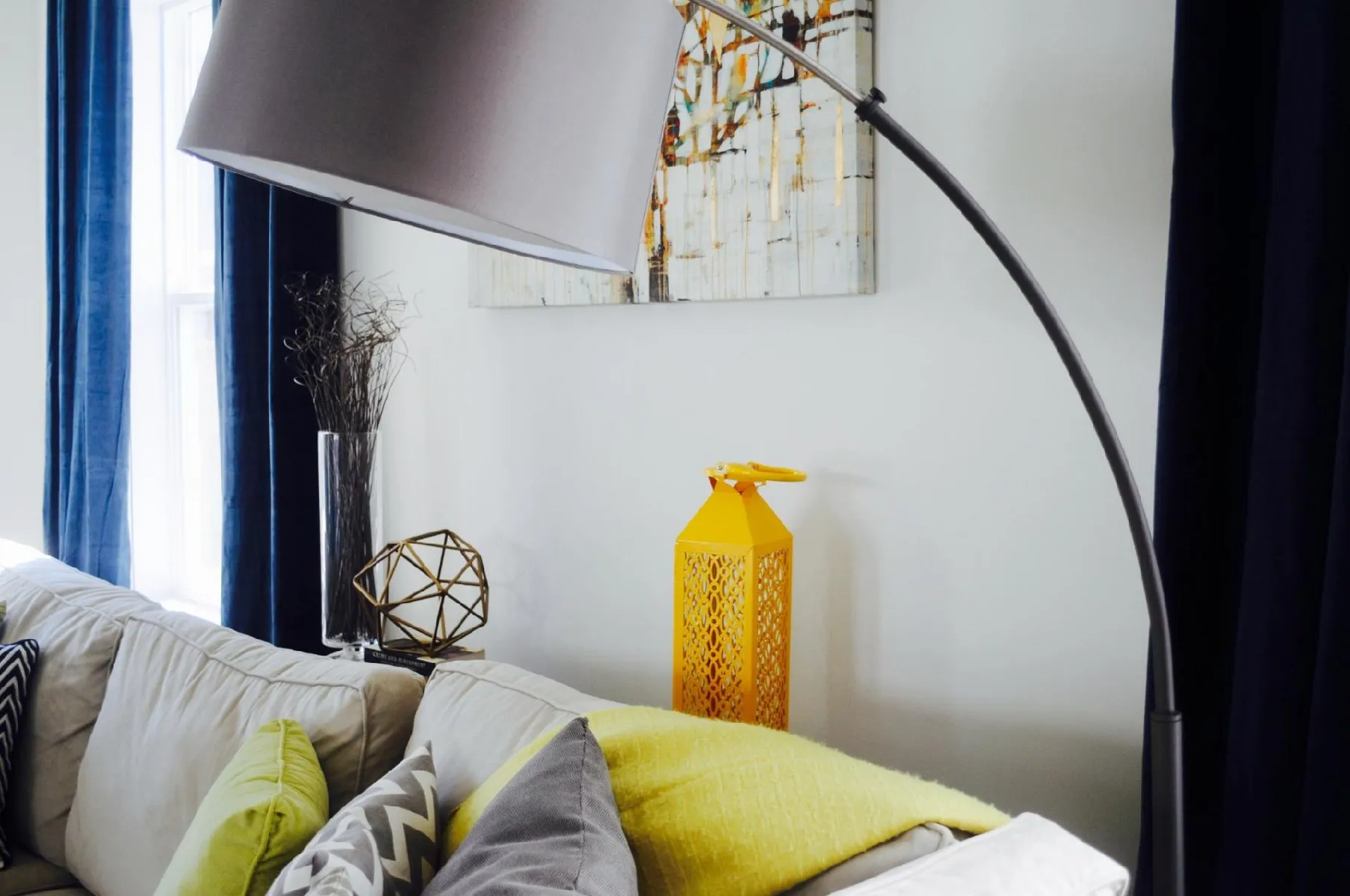 A cozy event setup featuring pillows, decor, and lighting.