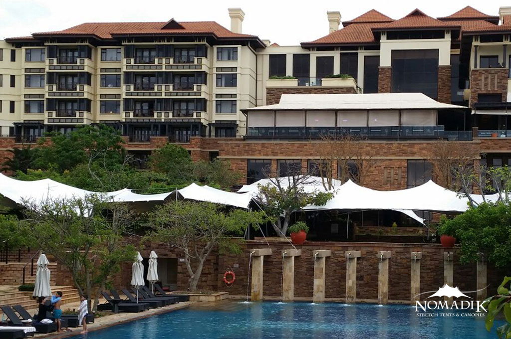 Stretch tent setup at a resort near a swimming pool
