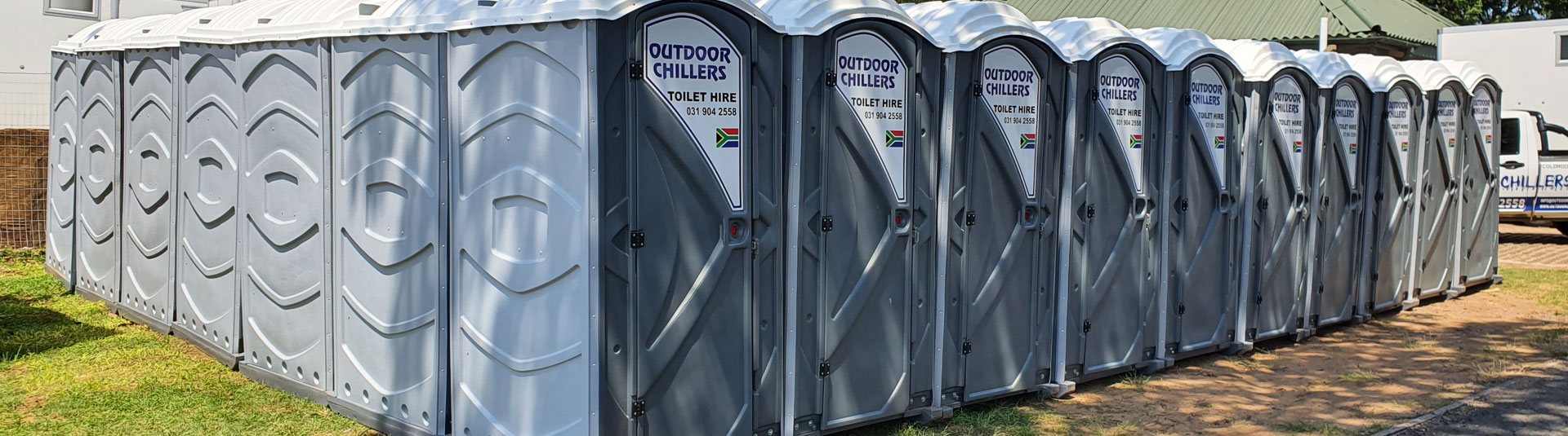 Line of grey portable toilets by Outdoor Chillers