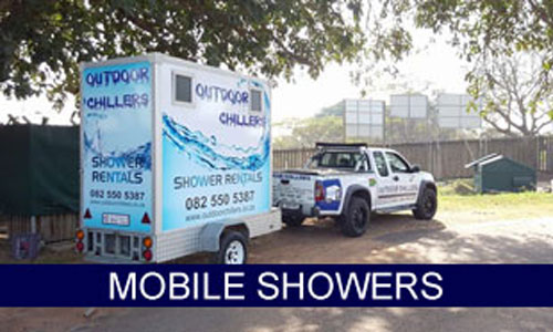Mobile shower trailer with branding parked beside a vehicle.
