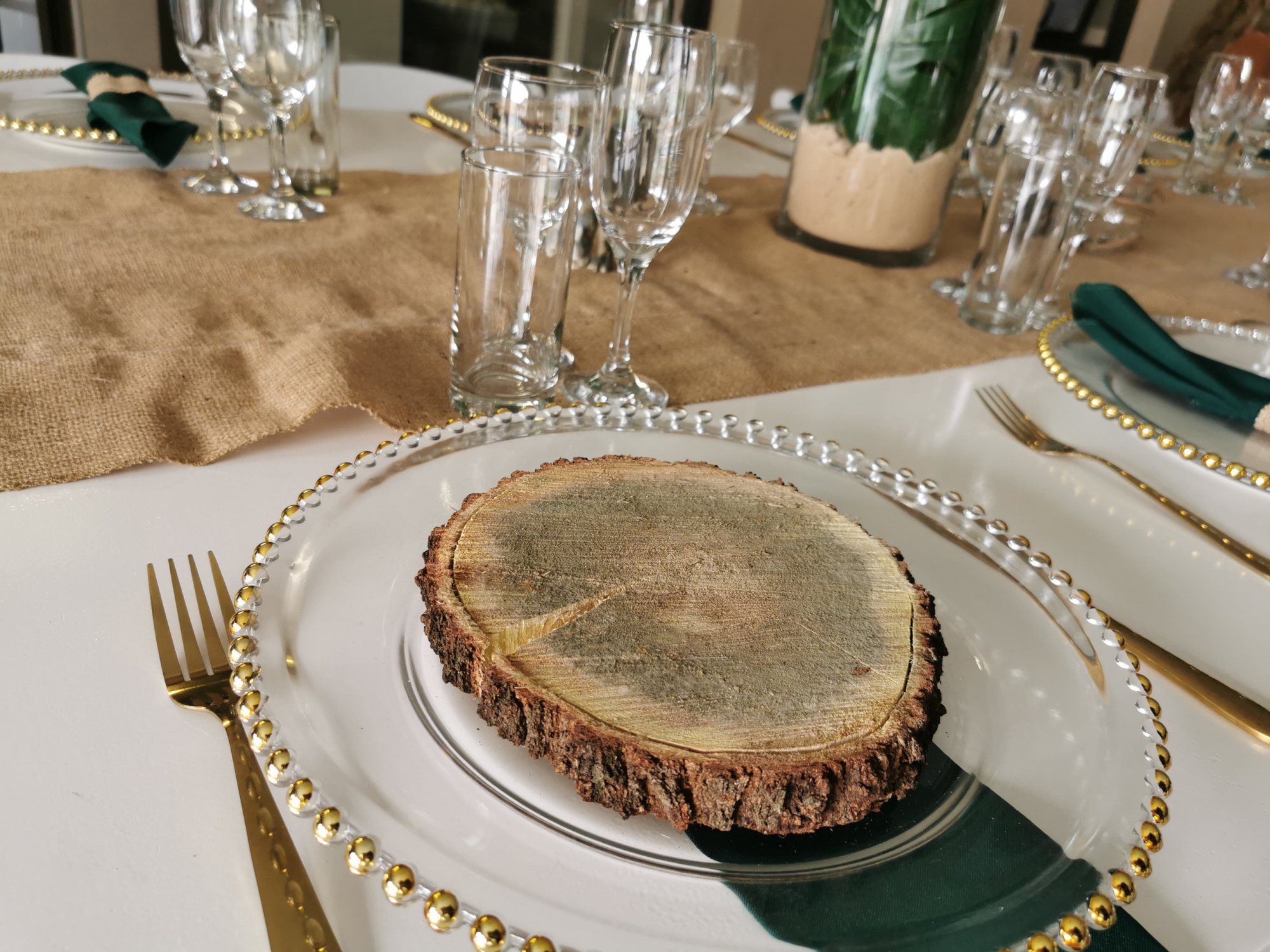 A rustic table setting featuring a wood slice as a plate.