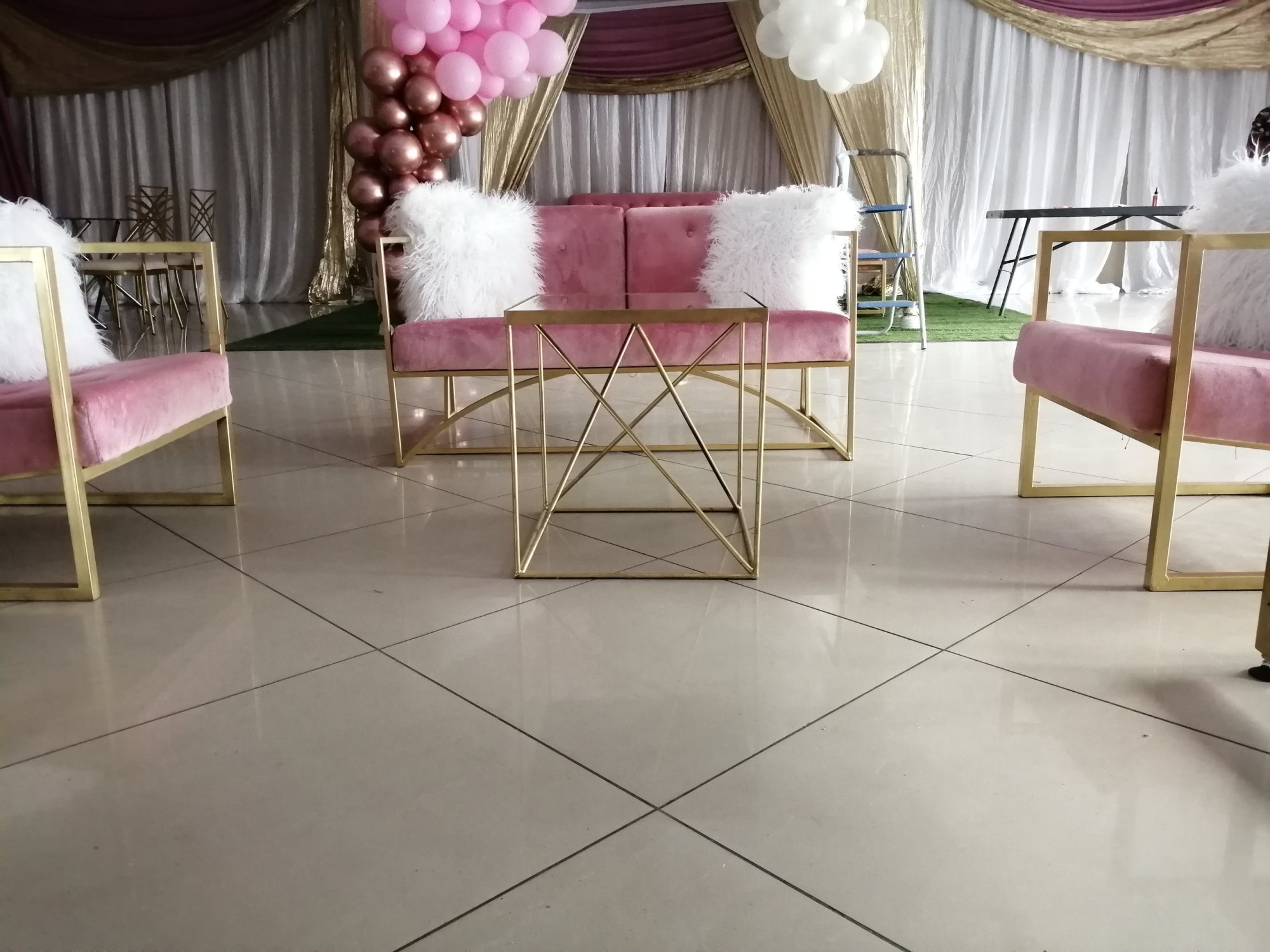 Chic lounge seating with pink couches and gold table