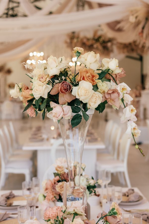 Tall vase with floral arrangement on a table
