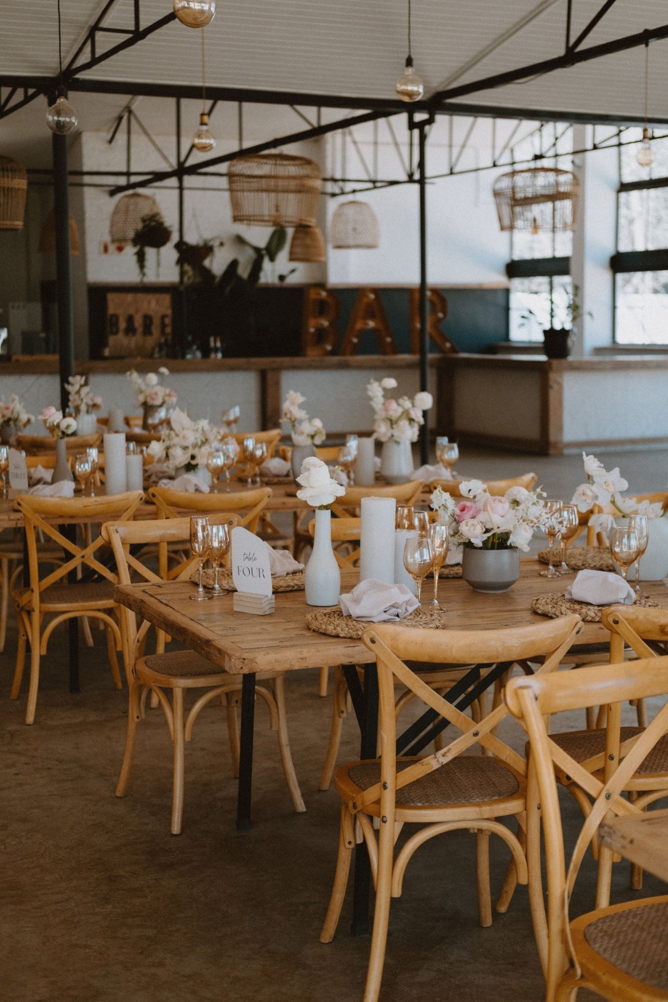 Rustic event setup with wooden tables and floral decorations