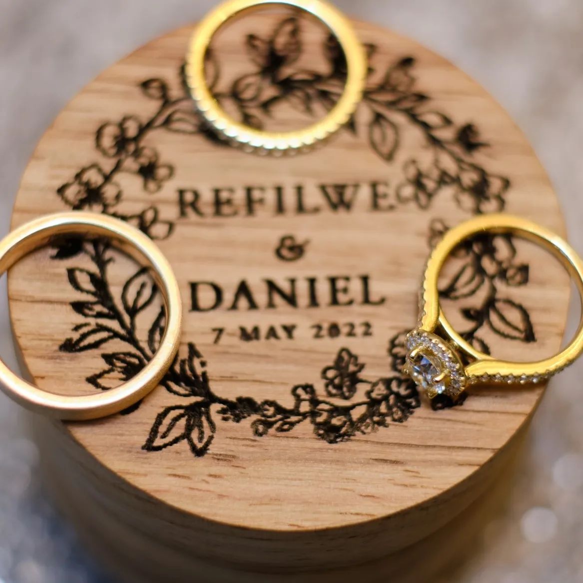 Engraved wooden ring box with wedding rings