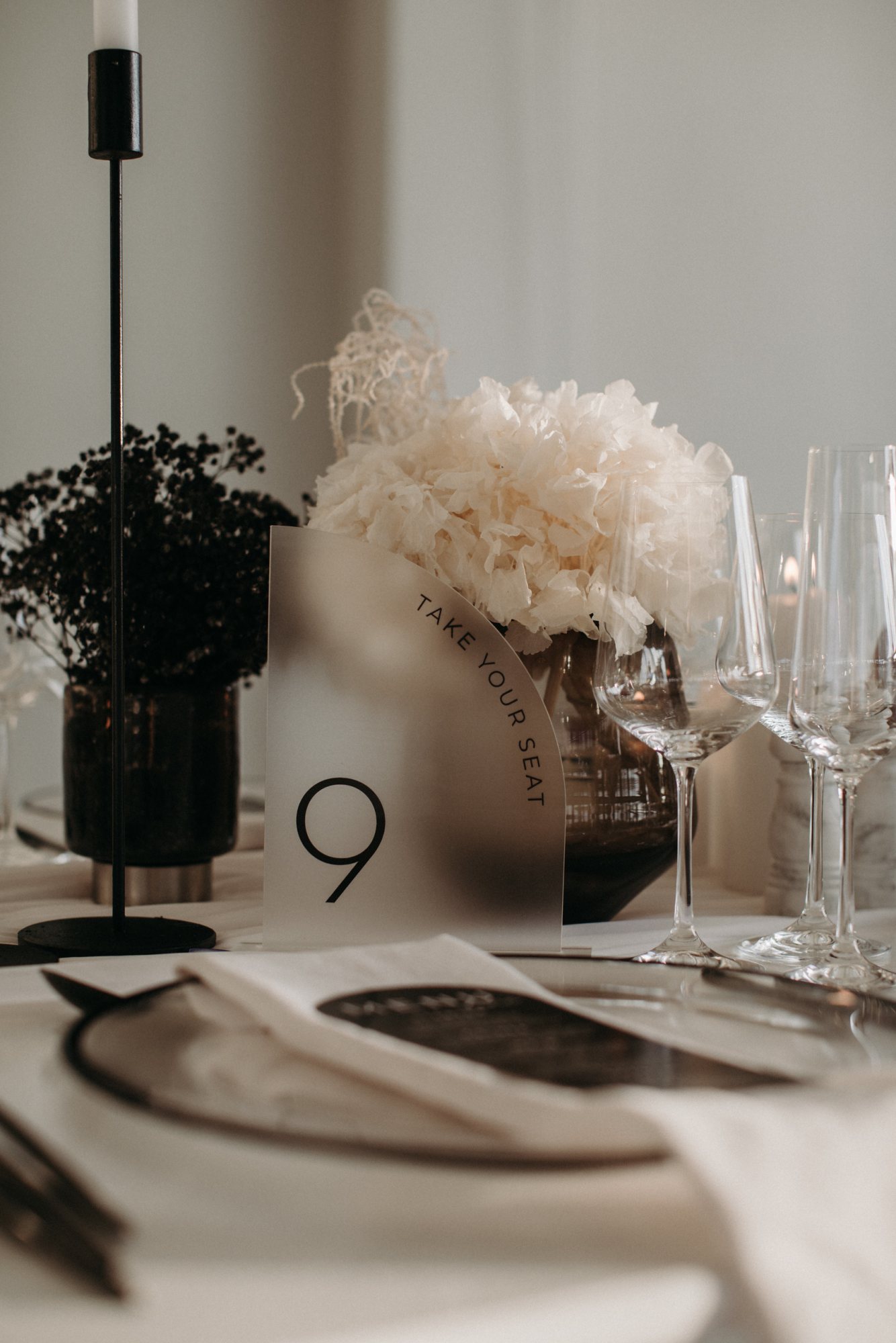 Table number 9 with floral arrangement and glassware