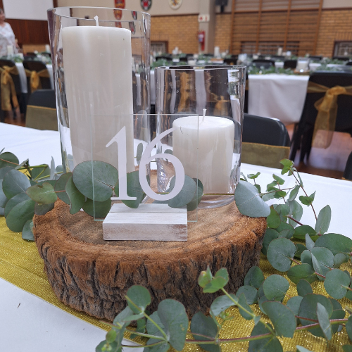 Candle centrepiece with wood base and eucalyptus decor