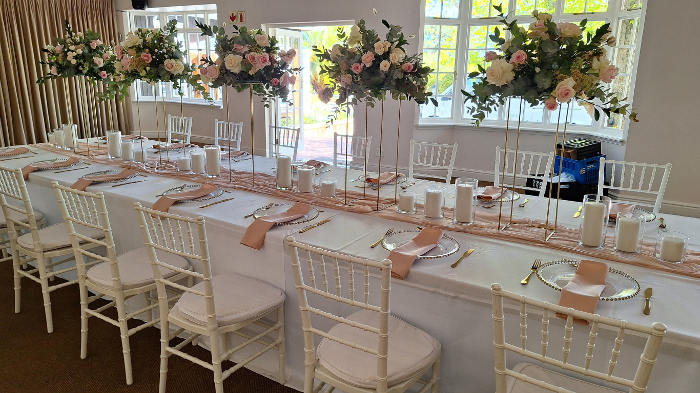 Long banquet table with flowers and candles